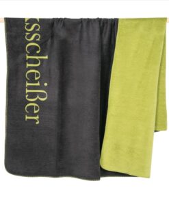 Grün graue Decke in Wendeoptik der Marke deutschen Marke PAD mit dem Schriftzug Glücksscheißer.